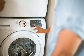 Woman points to the control panel of a washing machine at Indian Lookout, Ohio, 45449