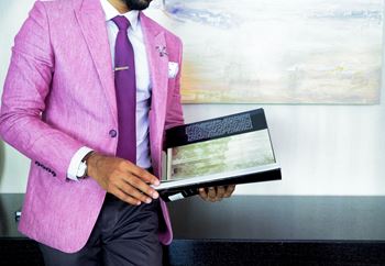 Man in a pink suit holding a book at Indian Lookout, West Carrollton