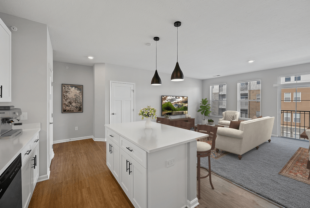 an open kitchen and living room with white cabinets and a white counter top at Monmouth Row Apartments, Newport, KY, 41071