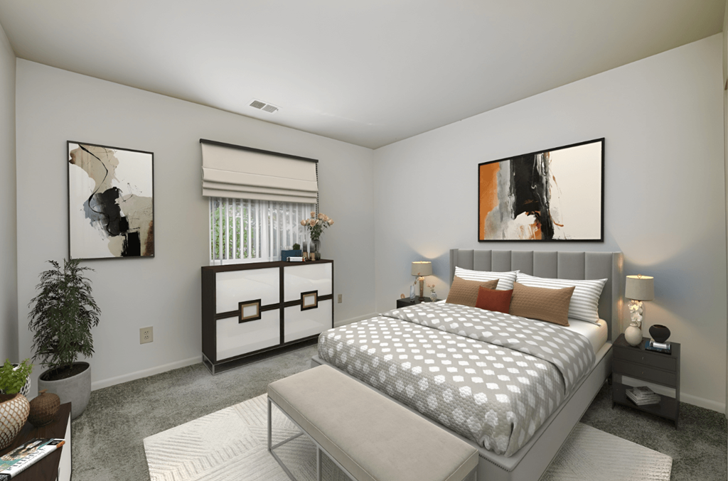 a bedroom with a bed and a table and a window at Quail Run Apartments, Columbus, IN, 47201