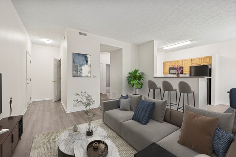 A living room with a grey couch and a coffee table.