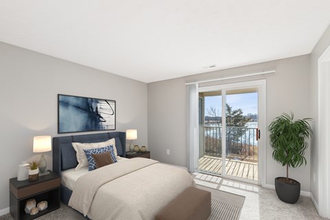 A bedroom with a large bed and a view of the outside.