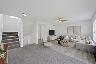 a living room with white walls and grey carpet - Photo Gallery 3
