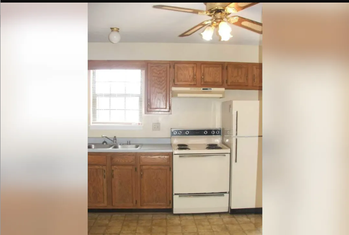 a kitchen with white appliances and wooden cabinets