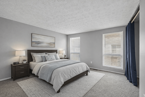 A bedroom with a large bed and a painting on the wall.
