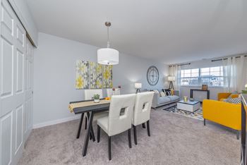 an open living room and dining room with a table and chairs