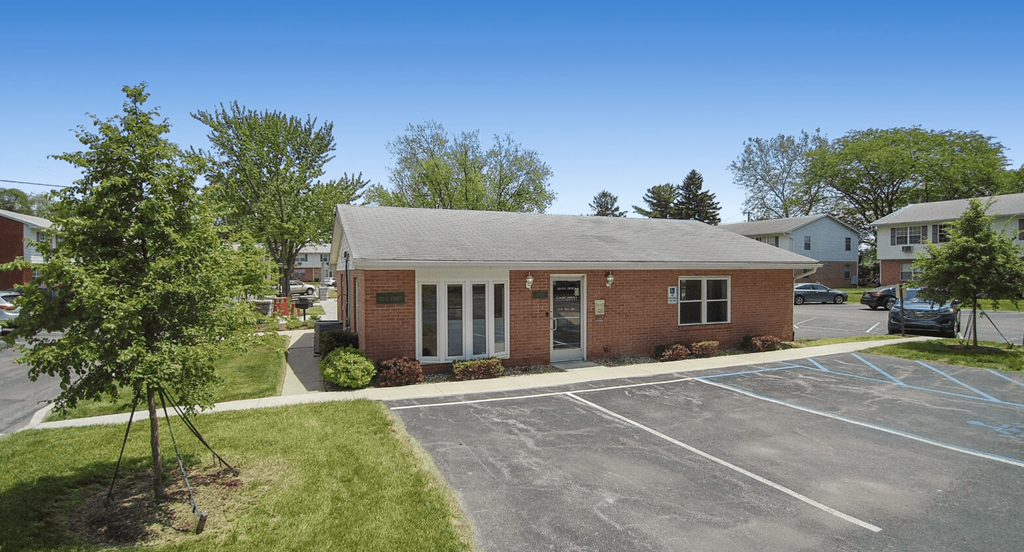 an empty parking lot in front of a brick building