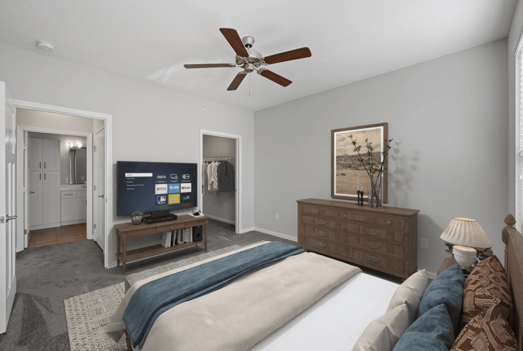 a bedroom with a large bed and a ceiling fan at Monmouth Row Apartments, Newport, 41071