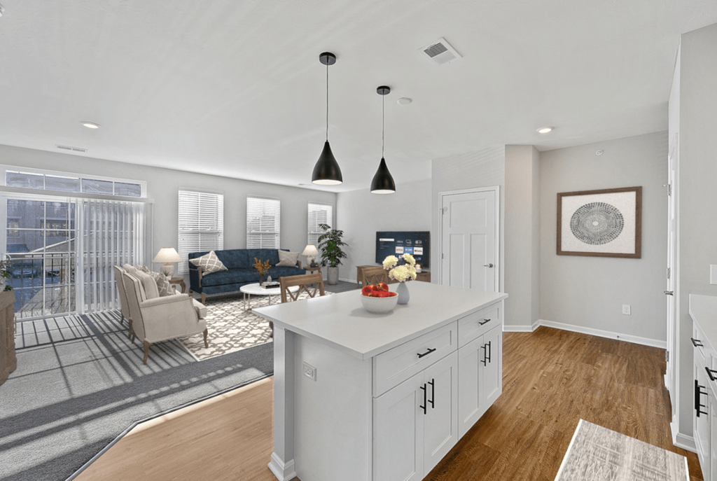 an open kitchen and living room with white cabinets and a white island at Monmouth Row Apartments, Newport