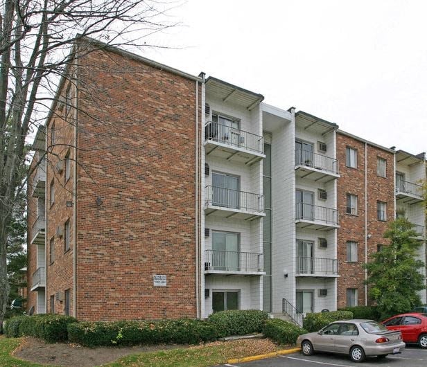 a car parked in front of an apartment building