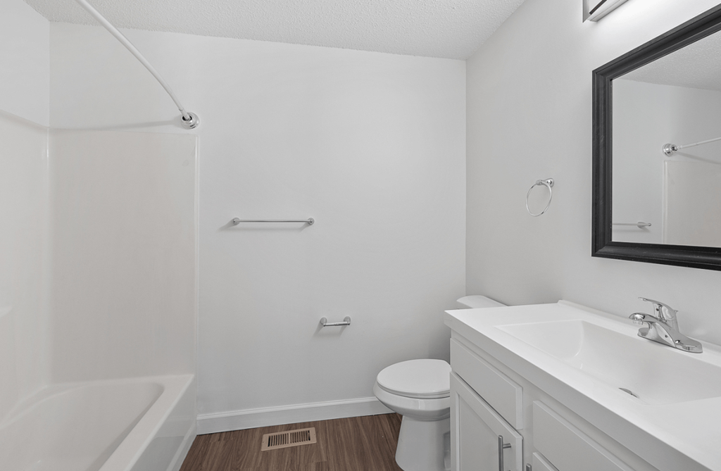 an empty bathroom with a sink toilet and bath tub
