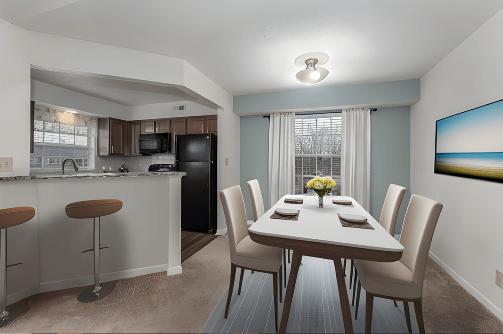 Dining room and kitchen with a table and chairs at Normandy Club, Centerville, OH, 45459