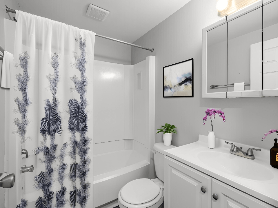 a bathroom with a shower curtain and a toilet and sink