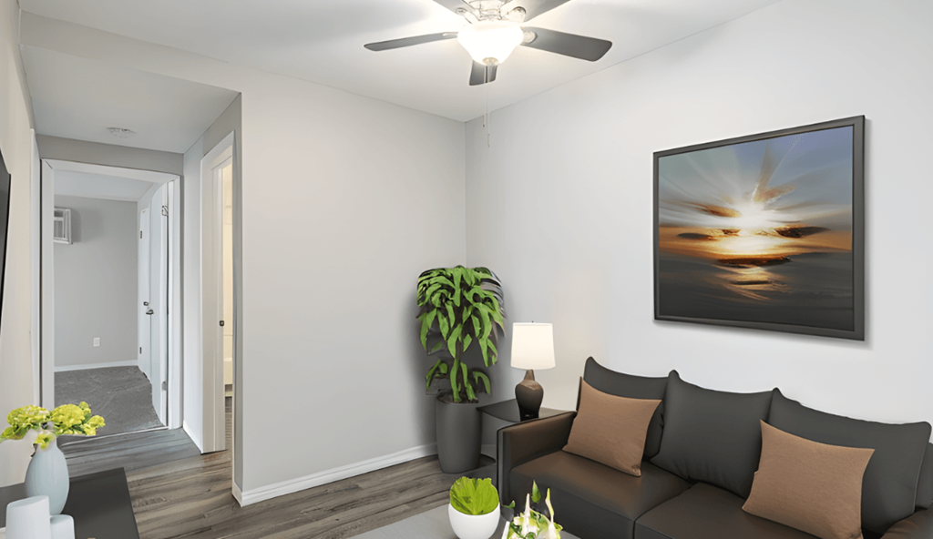 a living room with a couch and a ceiling fan