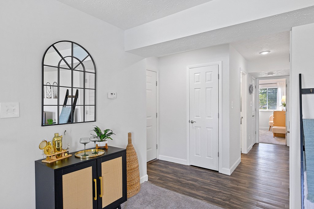 Living room and hallway with a black cabinet and a white door at Wrights Point, Ft Wright, KY