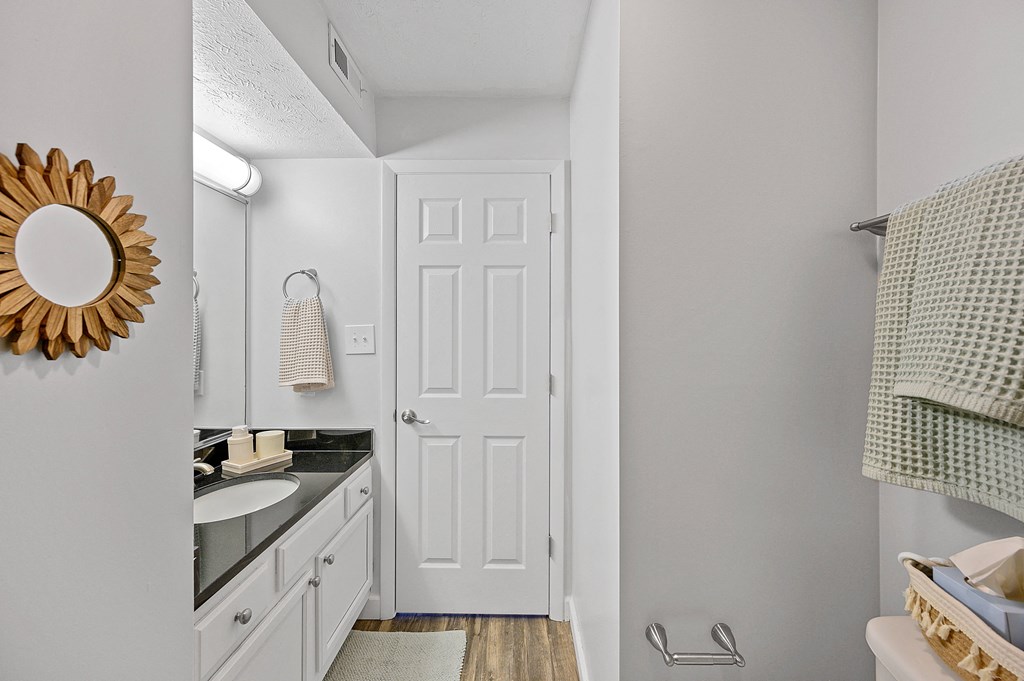 Bathroom with a white door and a sink and a mirror at Wrights Point, Ft Wright