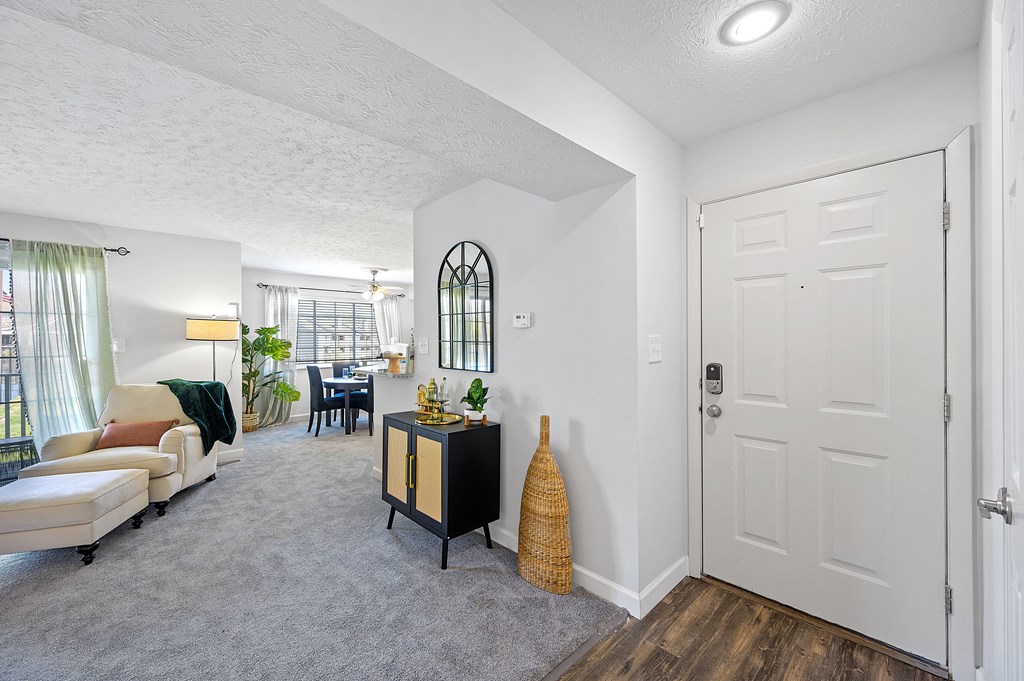 Open living room and dining room with a white door at Wrights Point, Ft Wright, KY