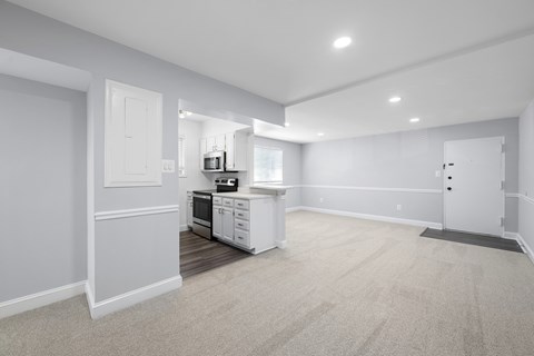 A kitchen with white appliances and cabinets is shown.
