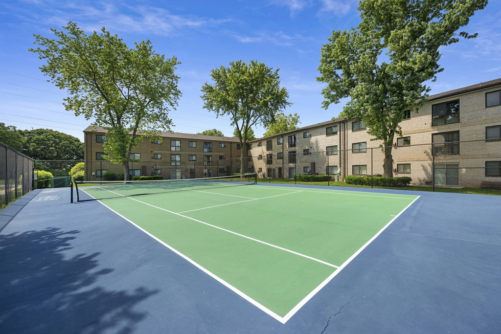 A tennis court is surrounded by apartment buildings at Rose Hill Apartments, Virginia, 22310