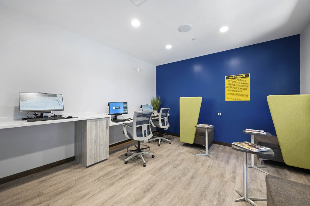 A room with a blue wall and a computer on a desk at Rose Hill Apartments, Alexandria, VA, 22310