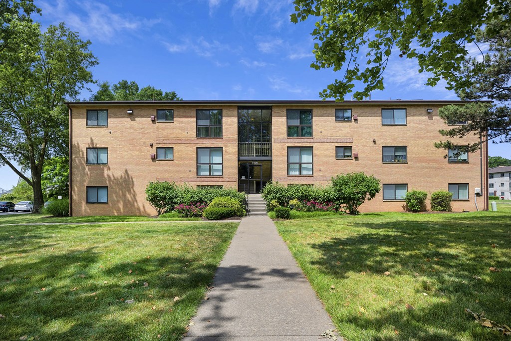 A large brick building with a walkway in front at Rose Hill Apartments, Alexandria, 22310