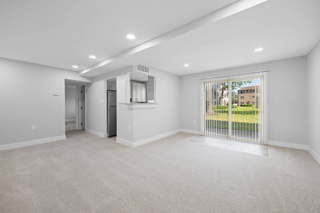 A spacious room with a carpeted floor and a window with blinds at Rose Hill Apartments, Alexandria, 22310