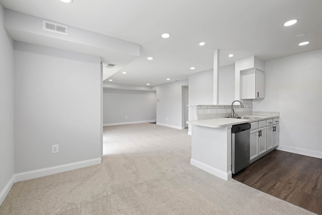 A spacious kitchen with white cabinets and a dishwasher at Rose Hill Apartments, Alexandria, Virginia
