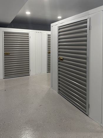A storage facility with closed doors and a concrete floor at Rose Hill Apartments, Alexandria