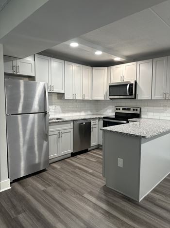 a kitchen with white cabinets and stainless steel appliances at Stuart Woods* Apartments, Herndon, VA, 20170