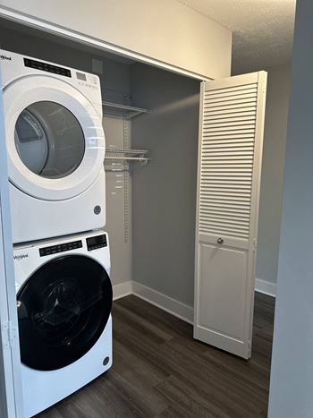 a washer and dryer in a laundry room with a closet at Stuart Woods* Apartments, Herndon, VA