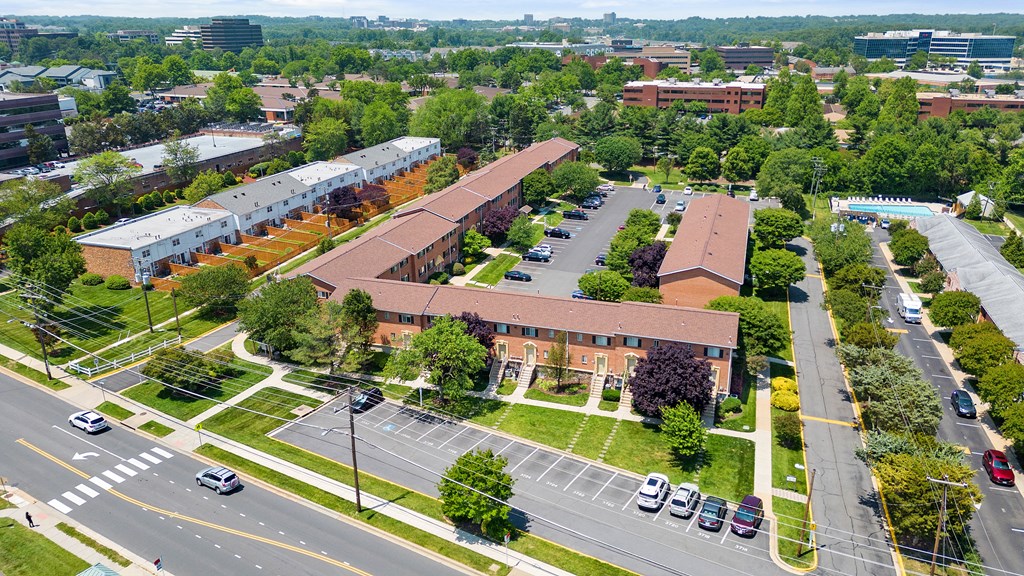 an aerial view of the campus with cars on the road and buildings at Gainsborough Court Apartments, Virginia