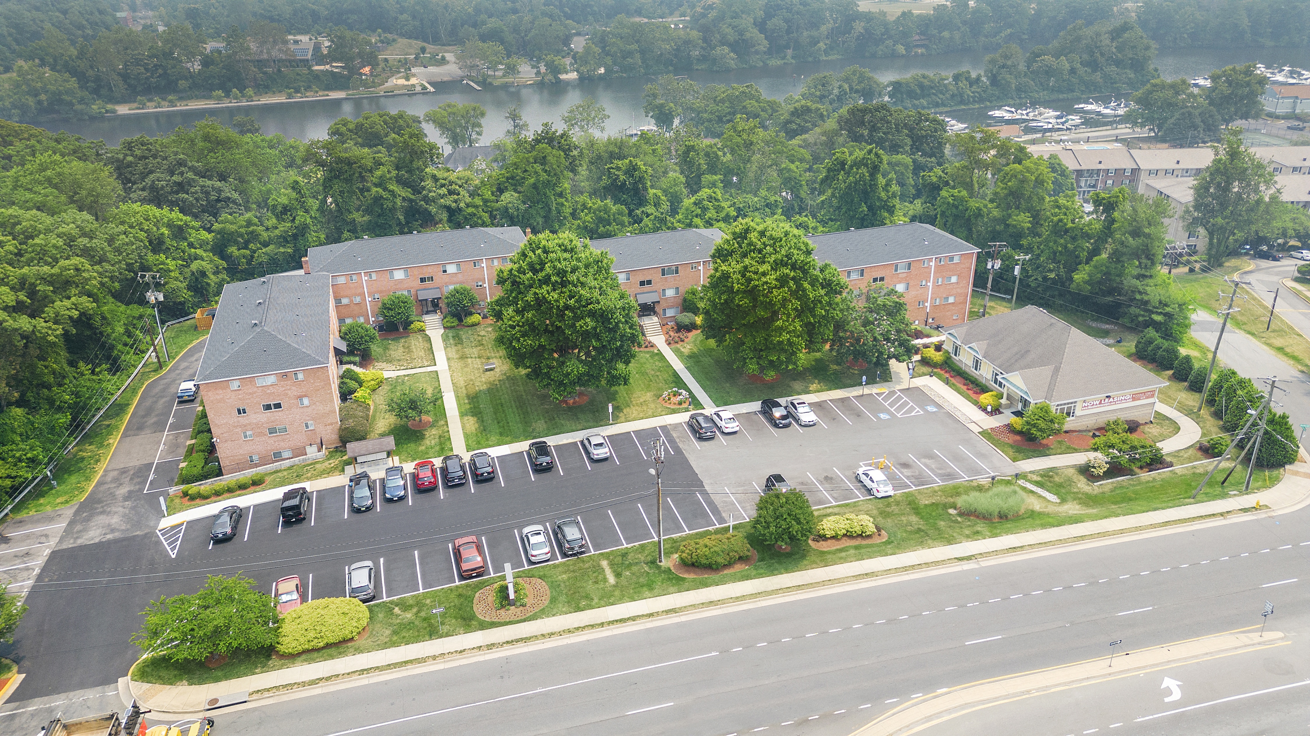 an aerial view of a parking lot in front of a building