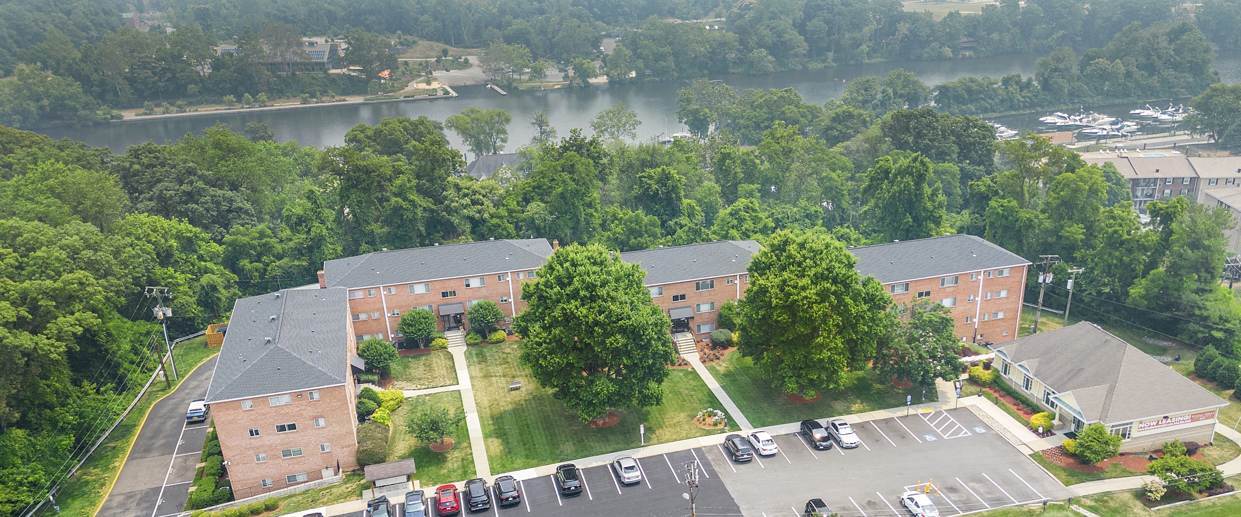 an aerial view of a parking lot in front of a building