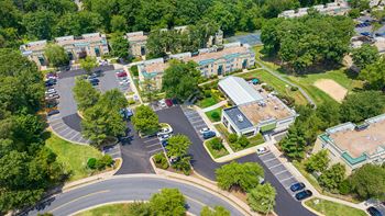 an aerial view of a city street with buildings and trees at Stuart Woods* Apartments, Herndon, VA