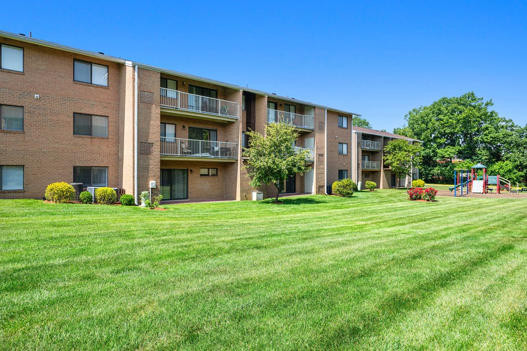 a view of an apartment complex with green grass in front of it at Gainsborough Court Apartments, Fairfax, 22030