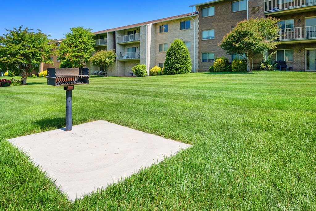 a mailbox on a pole in the middle of a grass field at Gainsborough Court Apartments, Fairfax, VA, 22030
