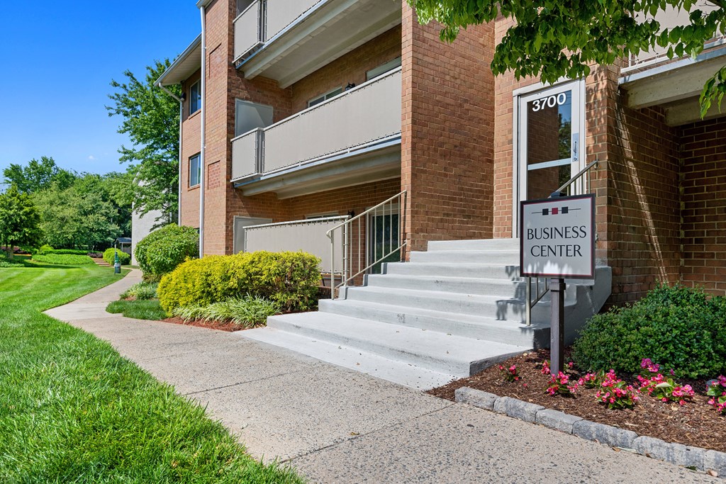 a business center sign in front of a brick building at Gainsborough Court Apartments, Fairfax, Virginia