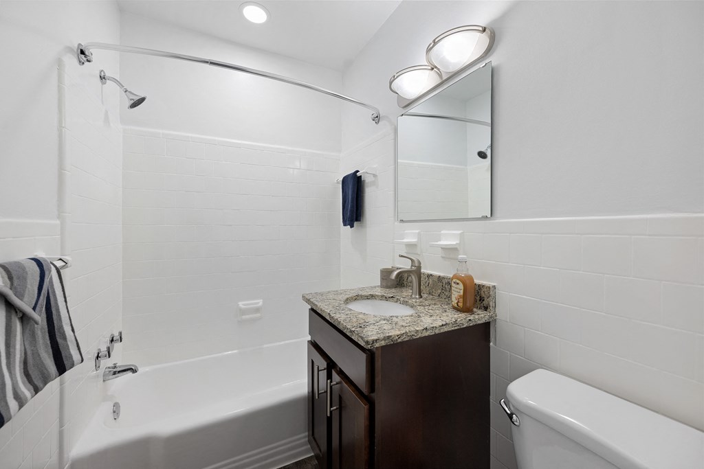 a bathroom with a sink and a bath tub and a shower at Gainsborough Court Apartments, Fairfax, VA