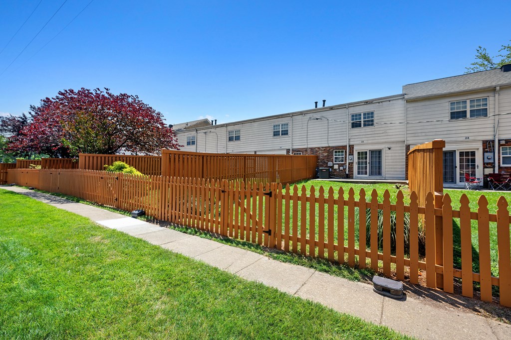 a wooden fence in front of a house at Gainsborough Court Apartments, Fairfax