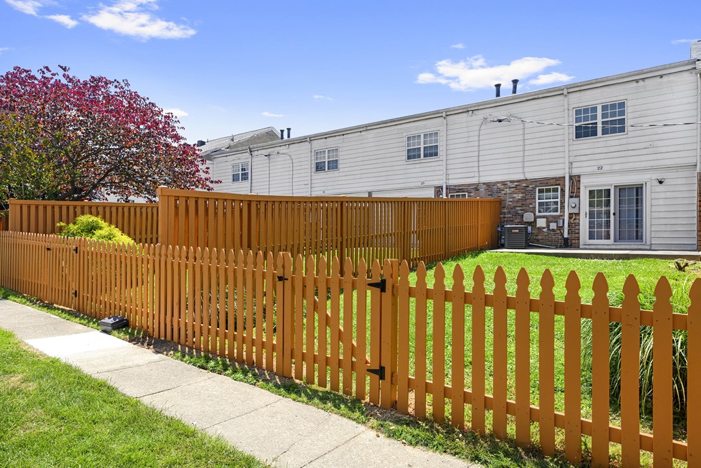 a wooden fence in front of a house at Gainsborough Court Apartments, Fairfax, 22030