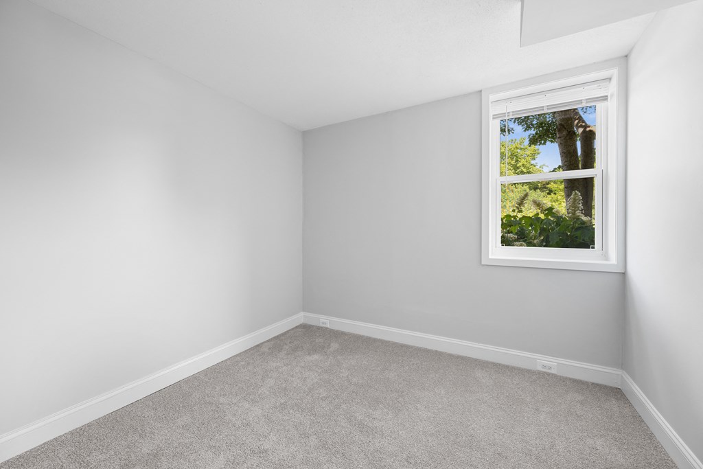 an empty room with white walls and a window at Stuart Woods* Apartments, Herndon, VA