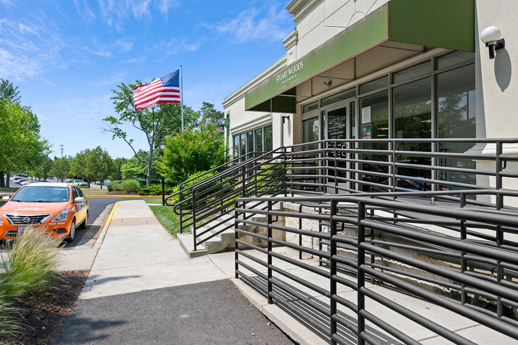 the front of a building with a car parked outside at Stuart Woods* Apartments, Virginia, 20170