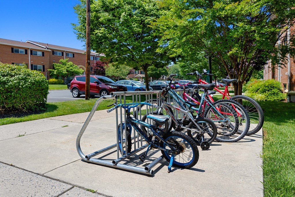 Row of bikes parked on a bike rack on a sidewalk at Gainsborough Court Apartments, Fairfax, VA