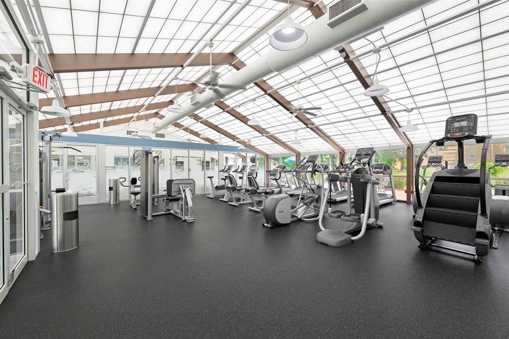a gym with treadmills and other exercise equipment at Stuart Woods* Apartments, Herndon, Virginia