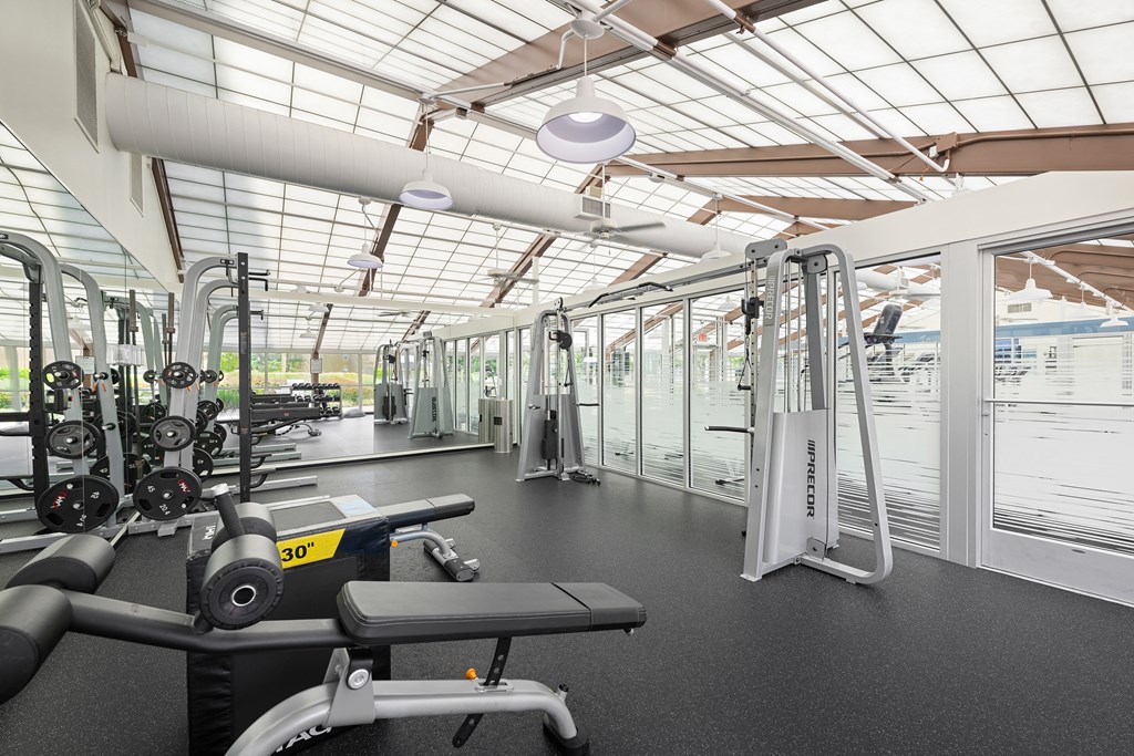 a gym with weights and other equipment and glass ceilings at Stuart Woods* Apartments, Virginia, 20170