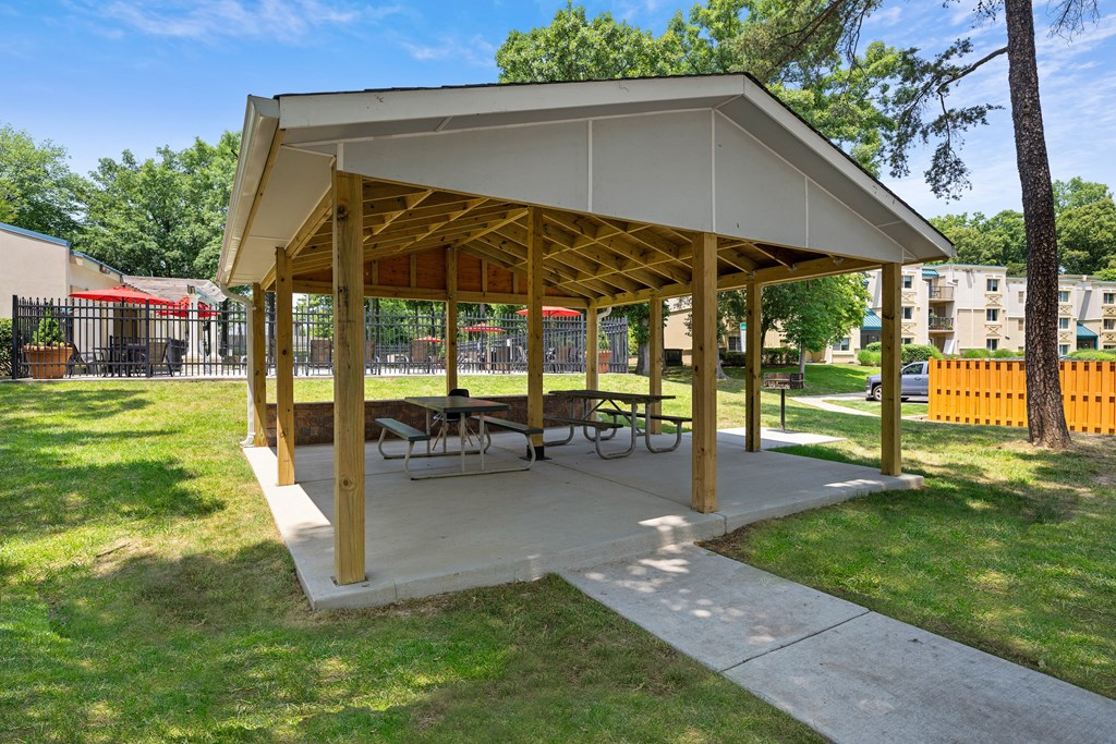 a picnic pavilion with benches and tables in a park at Stuart Woods* Apartments, Herndon, VA