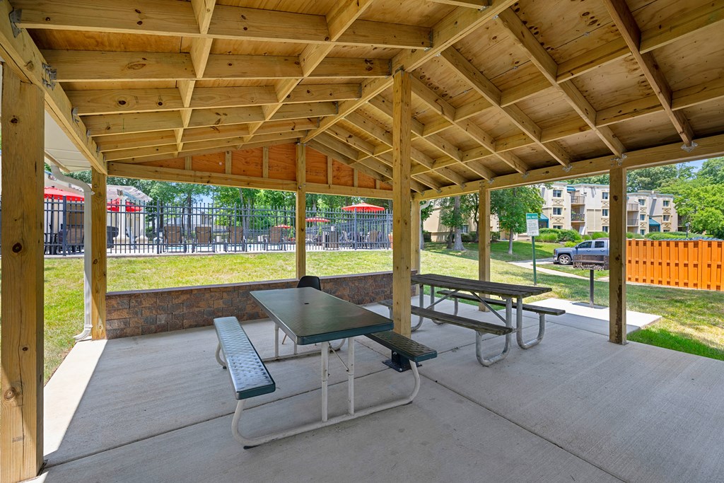 two picnic tables under a pavilion in a park at Stuart Woods* Apartments, Herndon, VA, 20170