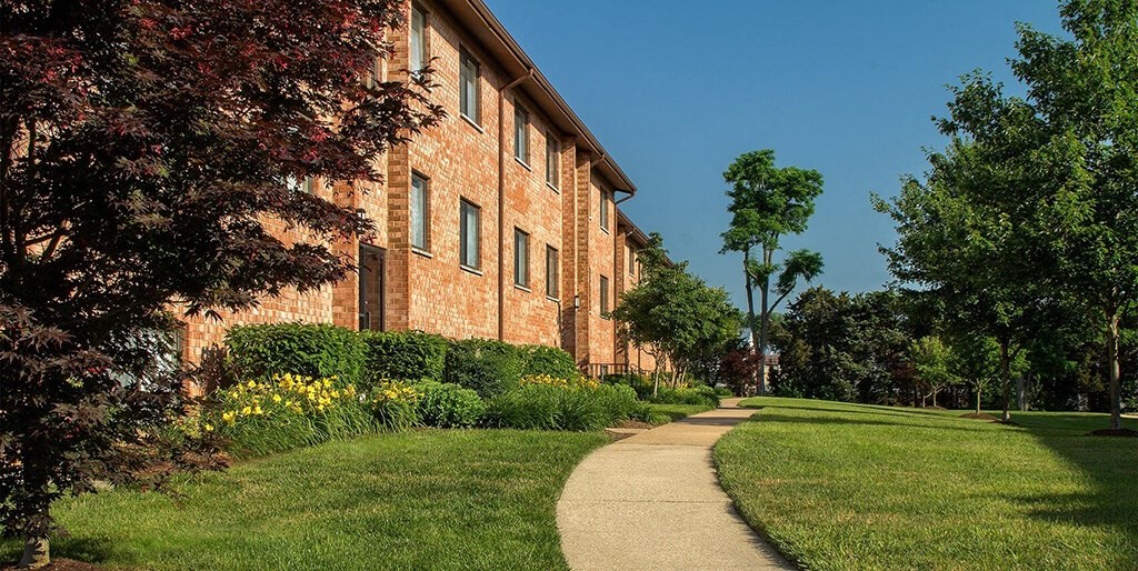 Pathway in front of apartment complex on sunny day at Rose Hill Apartments, Alexandria, VA