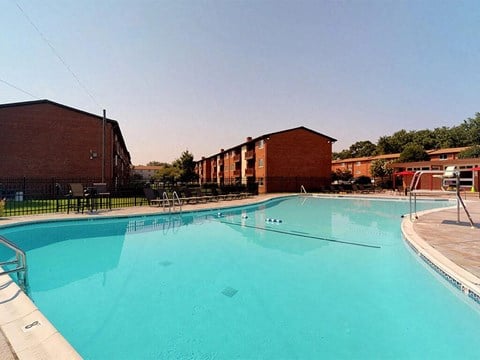 Large outdoor swimming pool area with sunshine at Rose Hill Apartments, Virginia