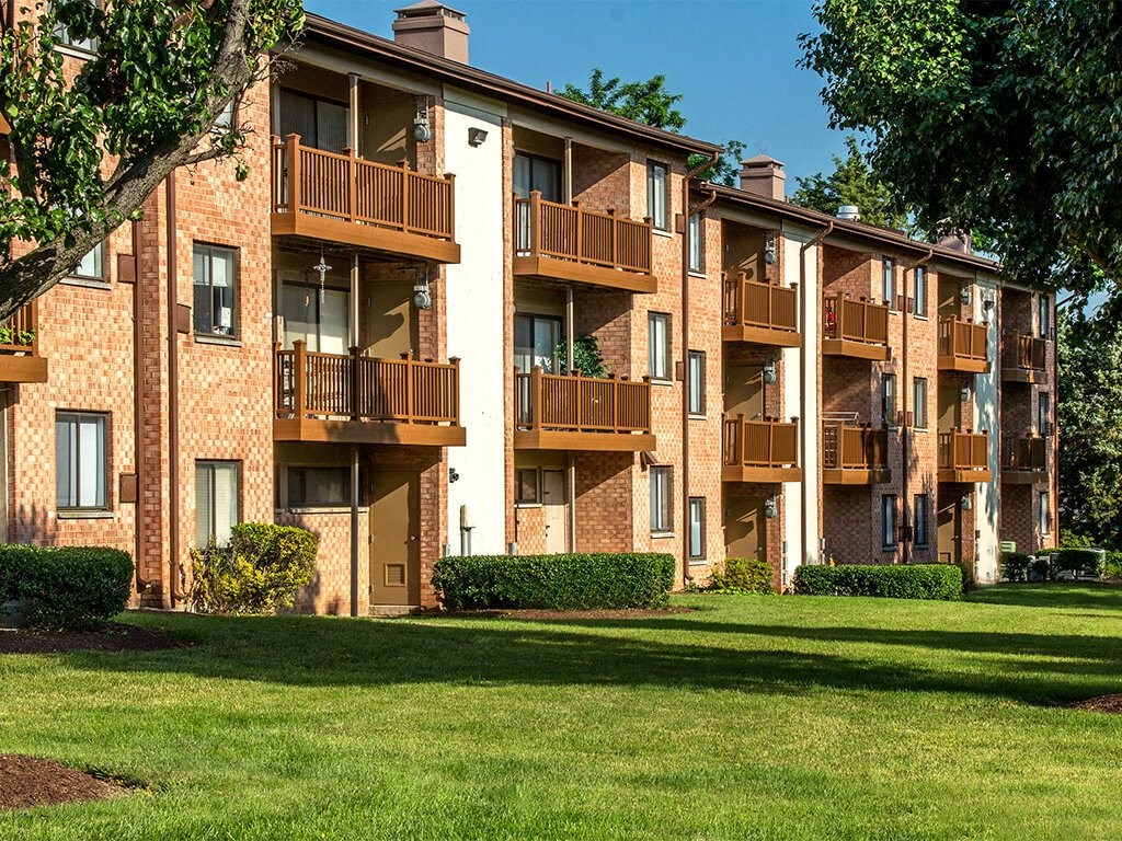 Exterior view of apartments with balconies during the day at Rose Hill Apartments, Alexandria, Virginia